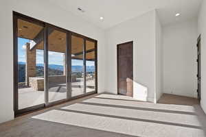Unfurnished room with light carpet and a mountain view