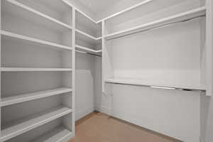 Walk in closet featuring light carpet