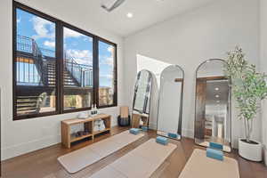 Office space with dark wood-style floors, recessed lighting, and healthy amount of natural light