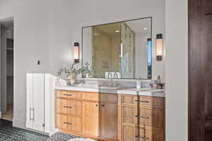 Bathroom featuring vanity and a shower stall