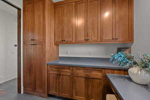 Kitchen featuring wood finish cabinets and dark countertops