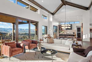 Living room with wood finished floors, hanging lights, and a mountain view