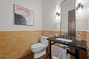 Bathroom featuring tile walls and a wainscoted wall