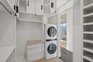Laundry area featuring stacked washer / drying machine