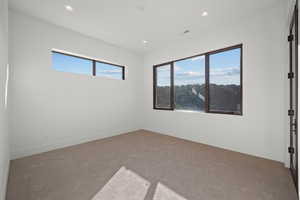 Spare room featuring carpet flooring and recessed lighting