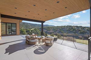 View of patio with an outdoor living space and a mountain view