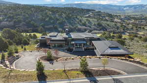 Aerial view of property and surrounding area with mountains