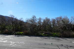View of asphalt street featuring a mountain view