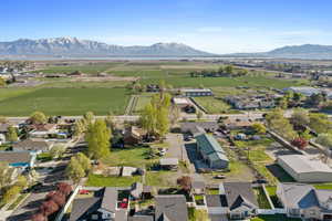 Aerial view of sparsely populated area featuring nearby suburban area and a mountain backdrop