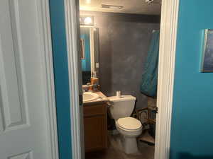 Basement bathroom with vanity, dark tile patterned flooring