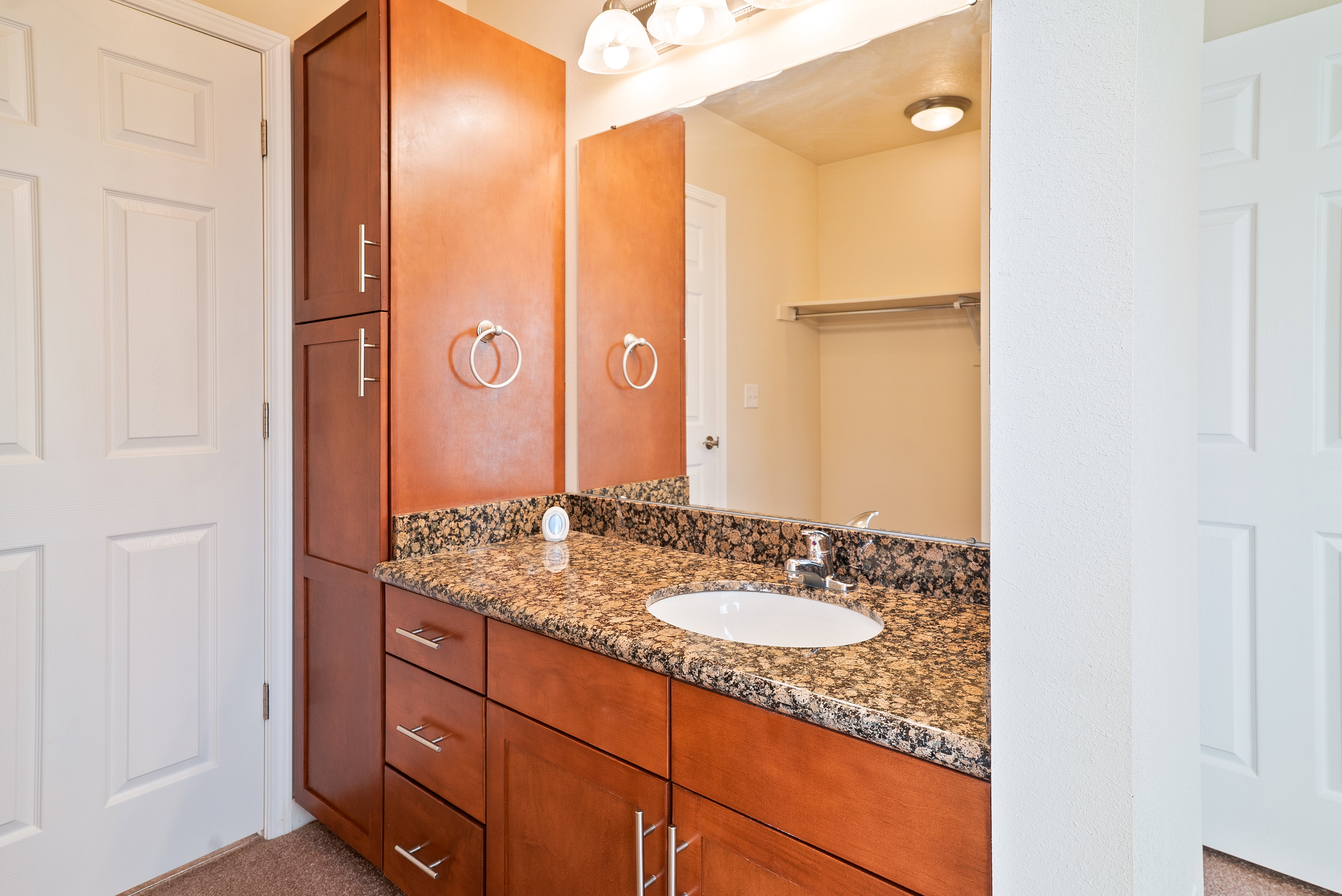 Bathroom featuring vanity and privacy door to hall bath