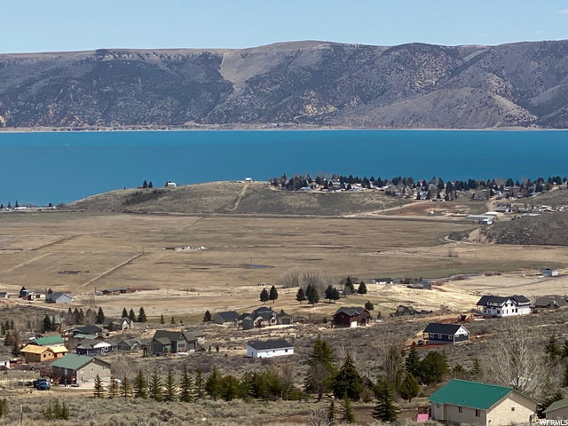 Aerial overview of property's location featuring a water and mountain view