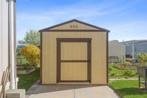 Storage shed in backyard providing additional space for tools, equipment, or seasonal items.