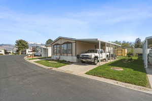 Corner lot perspective highlighting mountain views, covered parking, and open green space.