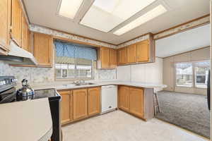 Kitchen with ample cabinetry, generous counter space, and window over sink providing natural light.