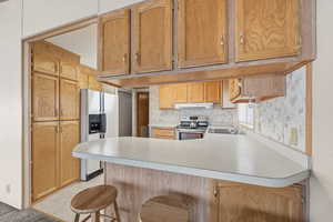 Functional kitchen layout with extended counter space, overhead cabinetry, and open connection to living area.