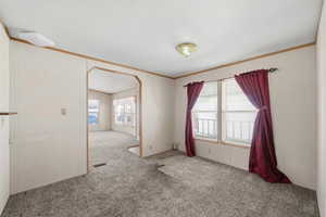 Additional living area featuring large window, natural light, and open flow to main room.