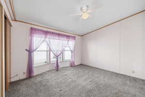 Spacious primary bedroom with large windows, ceiling fan, and plenty of natural light.