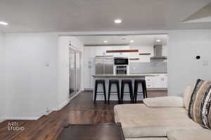 Living room with dark wood finished floors and recessed lighting