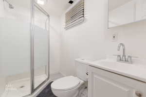 Bathroom featuring a stall shower and vanity