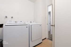 Laundry room featuring washer and clothes dryer