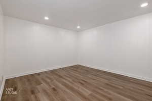 Unfurnished room with dark wood-type flooring and recessed lighting