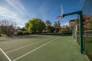 View of tennis court with community basketball court