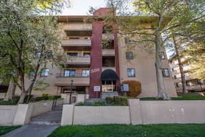 View of apartment building / complex featuring a fenced front yard