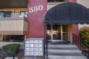 View of exterior entry featuring brick siding