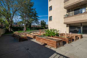 View of community with a garden, a patio, and a balcony