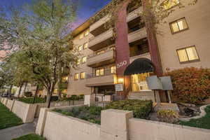 Property at dusk with a view of apartment building / complex