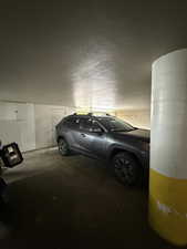 Garage featuring storage behind parking