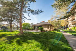 View of side of home with a patio, a lawn, and a sunroom