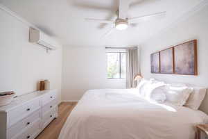 Bedroom featuring ornamental molding, light wood-style flooring, and ceiling fan