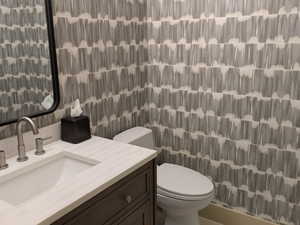 Half bathroom featuring vanity and light tile patterned floors
