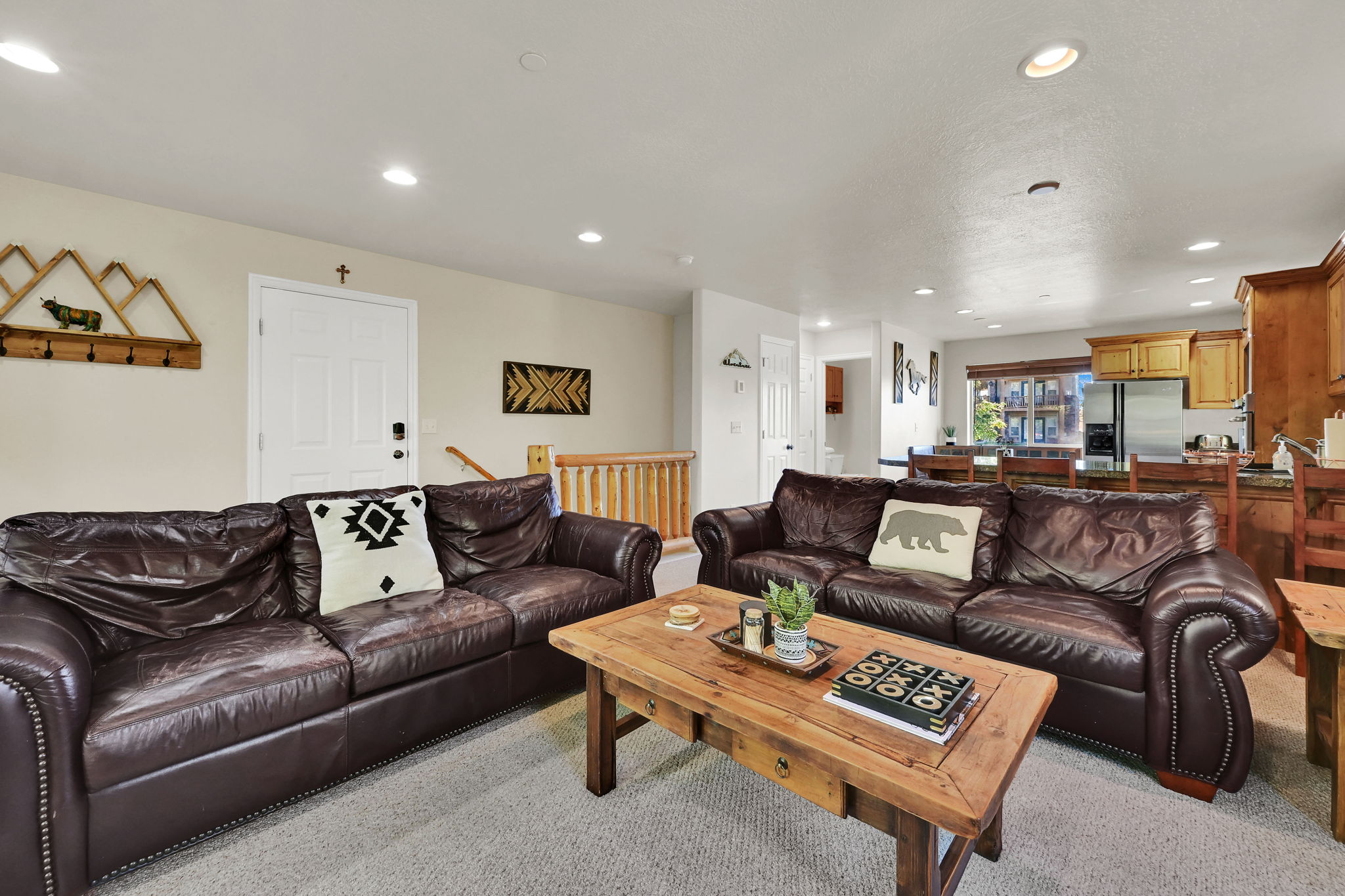 Living room with recessed lighting and light carpet