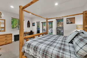 Bedroom featuring light carpet, recessed lighting, and access to outside