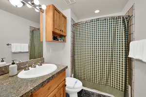 Full bathroom with vanity and a shower stall