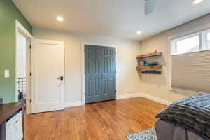 Bedroom 1 with light wood finished floors, a closet, recessed lighting, and a ceiling fan