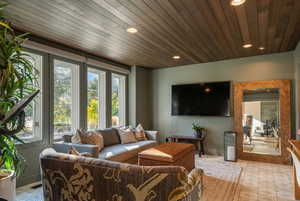 Living area with wooden ceiling and recessed lighting