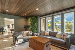 Living area featuring wood ceiling and recessed lighting