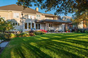 Back of property with outdoor seating, a patio, and a chimney