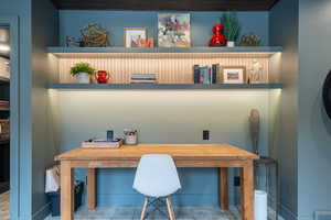 Office with built in study area and baseboards