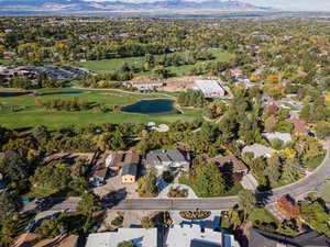View of property location with nearby suburban area, a large body of water, and a golf course