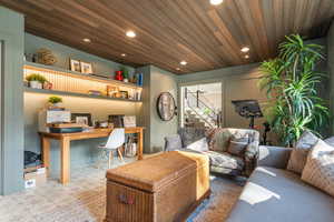 Living area with built in study area, wooden ceiling, recessed lighting, and tile patterned floors