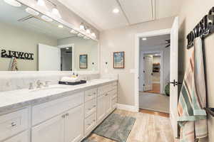 Bathroom with double vanity, recessed lighting, light wood-style floors, and ceiling fan