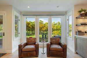 Doorway to outside featuring wood finished floors and baseboards