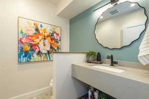 Half bath featuring toilet and vanity