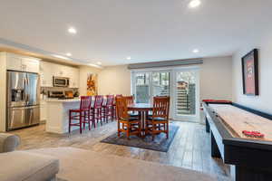 Dining area featuring light wood-style floors and recessed lighting