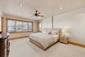 Bedroom featuring recessed lighting, ceiling fan, and light carpet